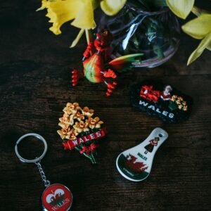 Collection of Welsh-themed souvenirs with yellow daffodil decorations on a rustic wooden surface.