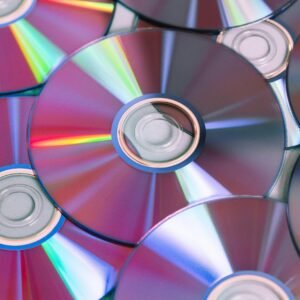 Vibrant close-up of compact discs showing colorful light refractions, ideal for themes of technology and entertainment.