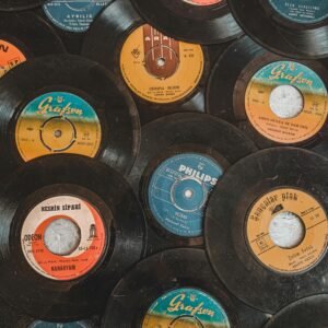 A nostalgic collection of vintage vinyl records displayed in a flat lay pattern.